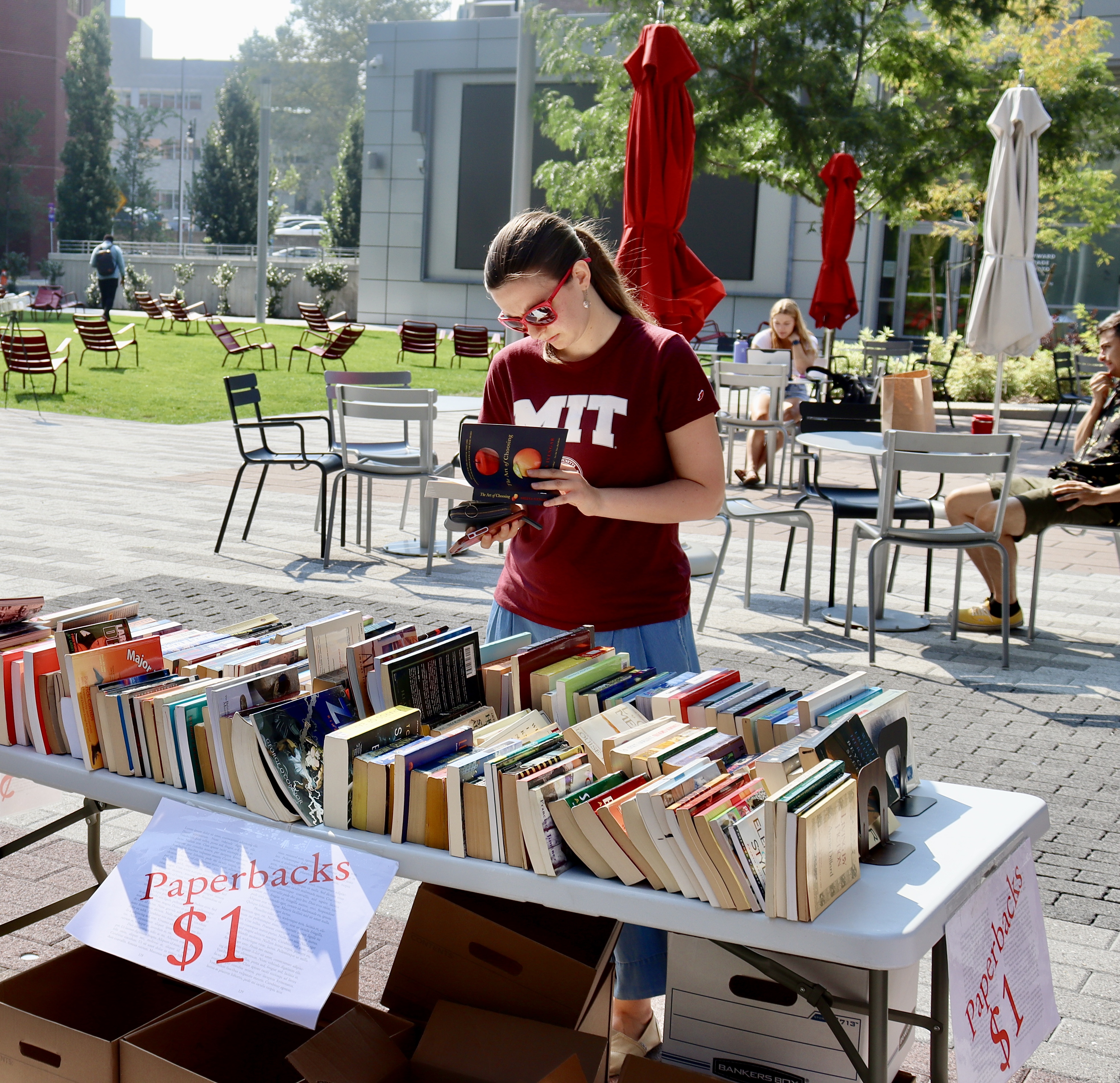 Caption:An MIT community member peruses the books, all of which were donated by MIT community.