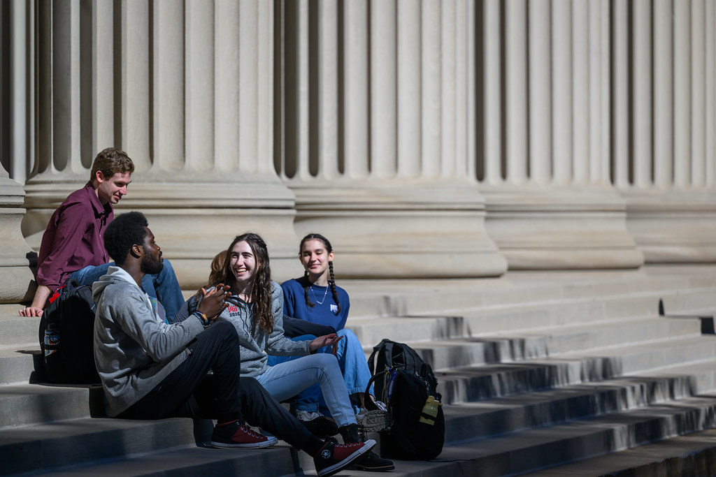 students sit on Killian steps
