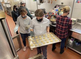 Volunteers for Open Learning's Day of Thanks bake cookies at CASPAR emergency shelter.