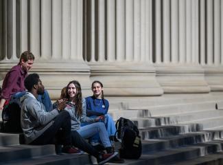 students sit on Killian steps